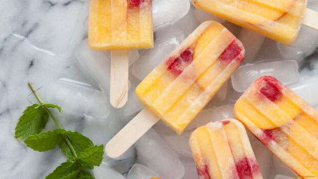 A close up of frozen fruit popsicles on ice with a sprig of mint, HD Desktop Wallpaper
