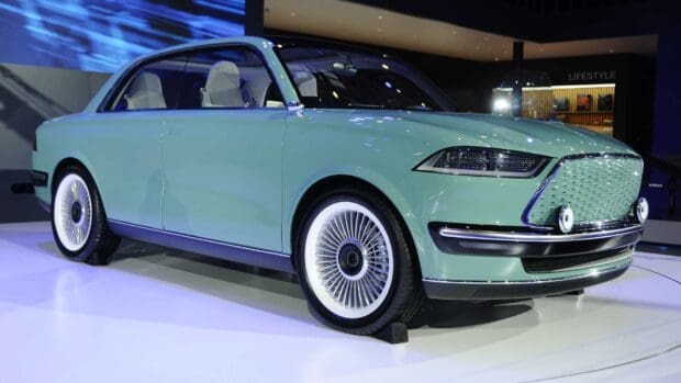 The Great Wall Motors car showcases a retro design with modern electric features in a showroom, HD Desktop Wallpaper