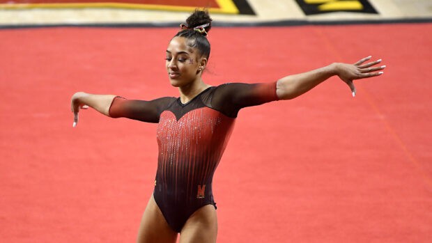 A rhythmic gymnastics athlete performs a routine on the red floor mat, HD Desktop Wallpaper