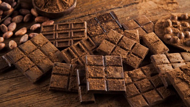 Various cocoa chocolates and cocoa powder arranged on wood, HD Desktop Wallpaper