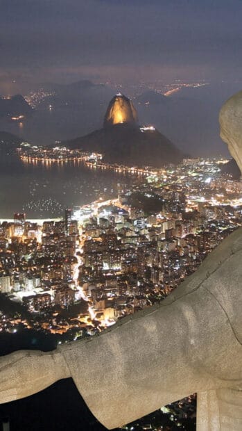 The city lights of Rio de Janeiro illuminate the bay with Sugarloaf Mountain glowing in the distance, HD Mobile Wallpaper