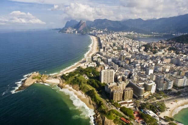 Aerial view of Rio De Janeiro showing the cityscape and coastline under cloudy sky, HD Desktop Wallpaper