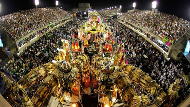 A vibrant Rio De Janeiro carnival parade with colorful costumes and large crowds at night, HD Desktop Wallpaper