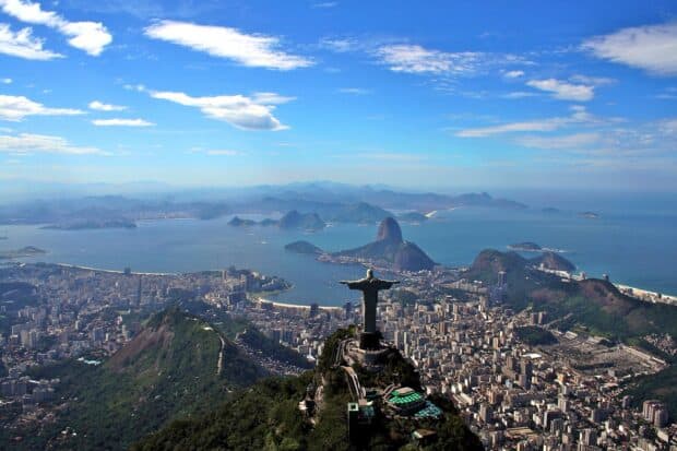 The Rio De Janeiro cityscape shows the Christ the Redeemer statue overlooking the bay and mountains, 2K Desktop Wallpaper