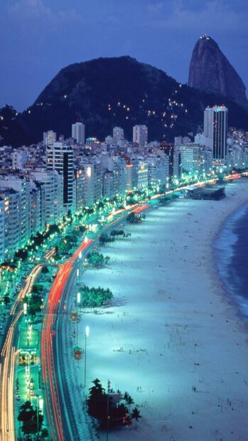 The night cityscape of Rio De Janeiro shows illuminated buildings and streets by the beach, HD Mobile Wallpaper