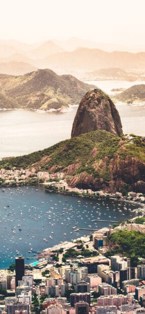 A scenic view of Rio De Janeiro showing mountains, water, and cityscape, 2K Phone Wallpaper
