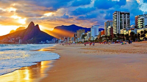 The sunset lights up Rio De Janeiro with mountains, beach, and city buildings, HD Desktop Wallpaper