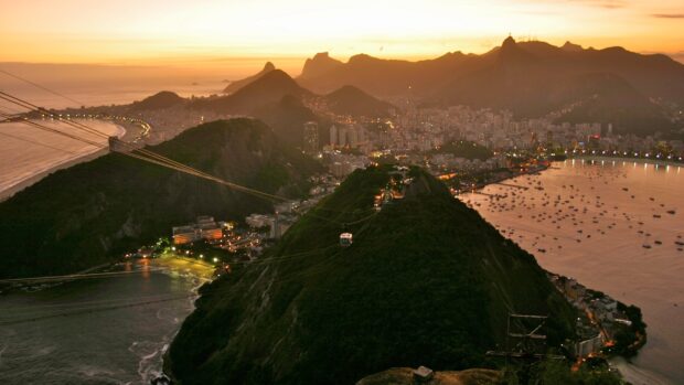 Rio De Janeiro showcases a beautiful sunset over city hills and beaches in this Rio De Janeiro Wallpapers, 2K Desktop Wallpaper