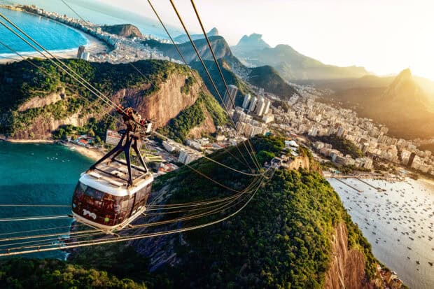 A cable car glides over lush hills and city buildings in Rio De Janerio, HD Desktop Wallpaper