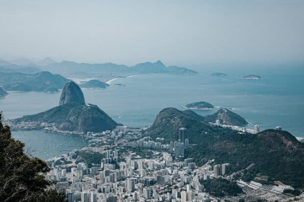 The Rio De Janerio Wallpapers show the city with surrounding mountains and ocean, HD Desktop Wallpaper