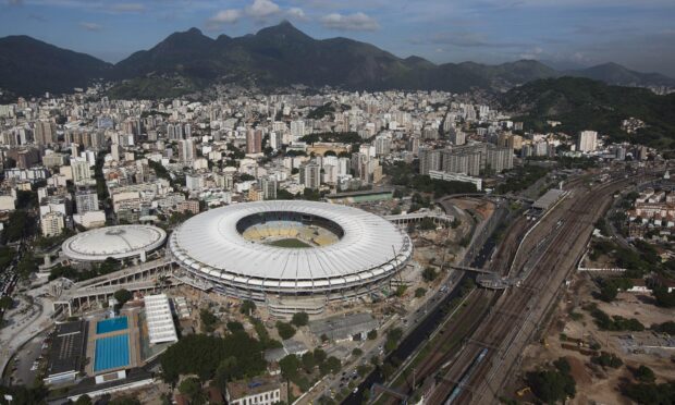 The Rio De Janerio Wallpapers city features a large stadium and mountain backdrop under a clear sky, 2K Desktop Wallpaper