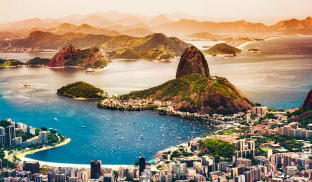 A stunning Rio De Janerio coastal view with mountains and city buildings under soft sunlight, HD Desktop Wallpaper
