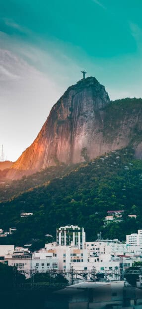 The Rio De Janerio Wallpapers feature the Christ the Redeemer statue on a mountain at sunset, 2K Phone Wallpaper