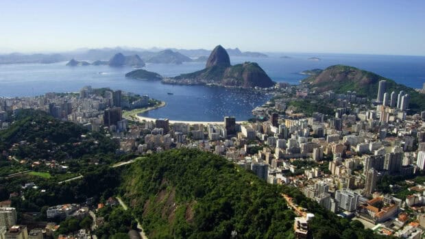 A panoramic view of Rio De Janerio showcases lush hills and ocean, 4K Desktop Wallpaper
