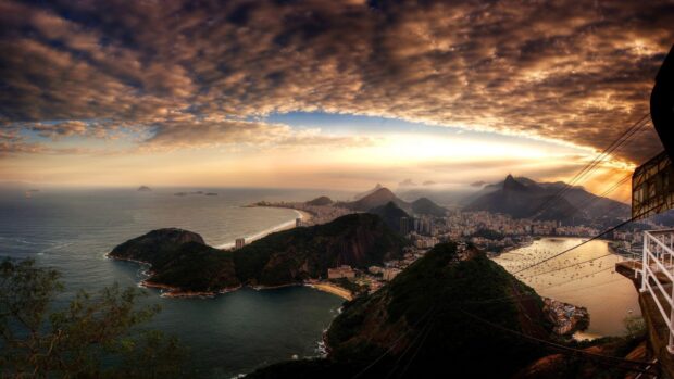 A panoramic view of Rio De Janerio showcasing the coastline and city under a dramatic sky, 2K Desktop Wallpaper
