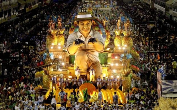 A vibrant carnival parade with a large figure and festive decorations in Rio de Janeiro, HD Desktop Wallpaper