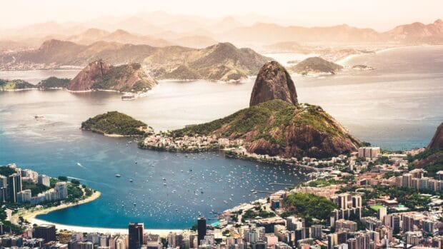 A panoramic view of Rio de Janeiro city featuring Sugarloaf Mountain and the bay, 2K Desktop Wallpaper