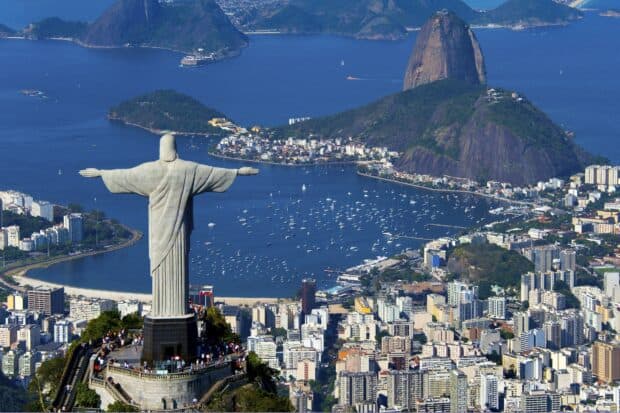 The Christ the Redeemer statue overlooks Rio de Janeiro city and Guanabara Bay under a clear sky, HD Desktop Wallpaper