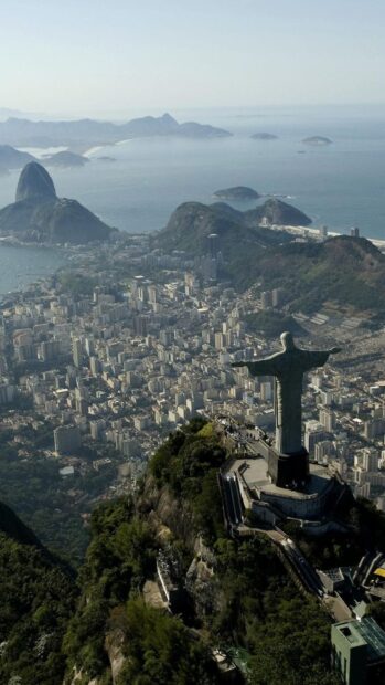 The Christ the Redeemer statue overlooks Rio de Janeiro city and coastline under a clear sky, HD Mobile Wallpaper