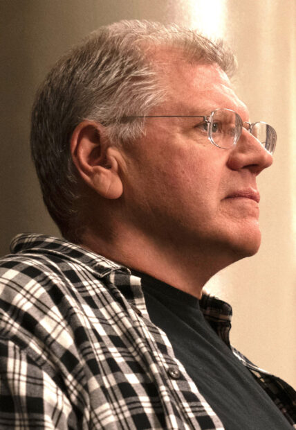 A close up portrait of Robert Zemeckis wearing glasses and a checkered shirt, 2K Phone Wallpaper