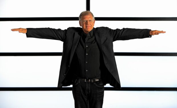 Robert Zemeckis is standing with his arms stretched out in front of a white background with black lines, HD Desktop Wallpaper