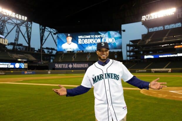 Robinson Cano stands on the field in a Seattle Mariners uniform during a stadium event, HD Desktop Wallpaper