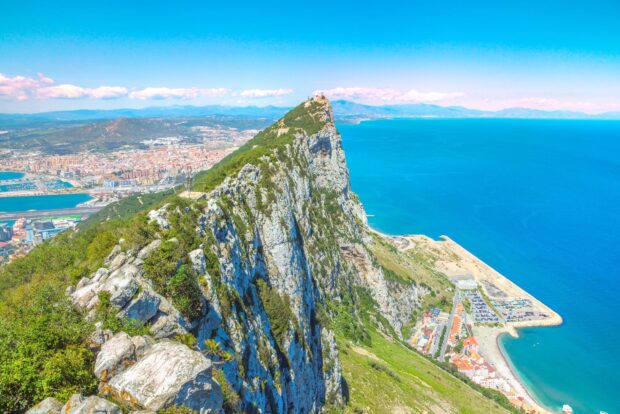 A stunning view of the rock formation and cityscape in Gibraltar captures natural beauty, HD Desktop Wallpaper