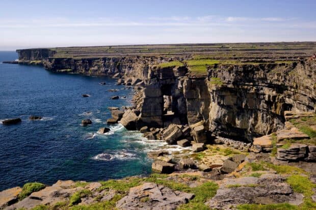 The Aran Islands feature rugged cliffs and blue ocean waters on a sunny day, HD Desktop Wallpaper