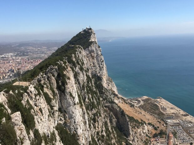 The rocky landscape of Gibraltar overlooks the deep blue sea and surrounding city, HD Desktop Wallpaper