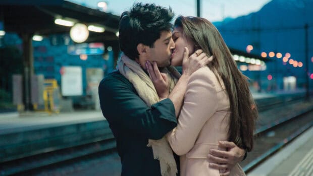 A couple sharing a romantic kiss at a train station in Bollywood Wallpapers, HD Desktop Wallpaper
