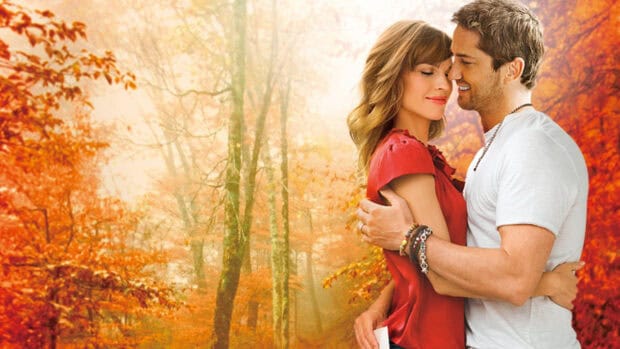 A couple shares a tender moment in an autumn forest with Hilary Swank, HD Desktop Wallpaper