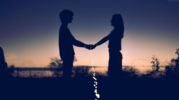 A love couple holding hands with glowing lights during sunset, 4K Desktop Wallpaper