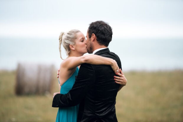 A romantic couple shares a kiss in an outdoor setting from The Bachelor Tv Series, HD Desktop Wallpaper