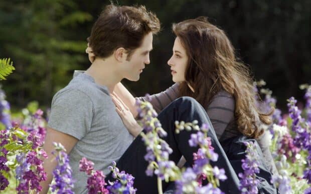 A romantic moment between characters in Twilight movie surrounded by flowers, HD Desktop Wallpaper