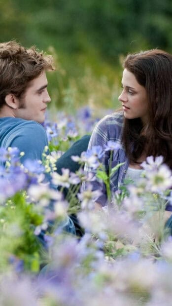 A romantic moment between two characters in a field of flowers from Twilight movie, HD Phone Wallpaper