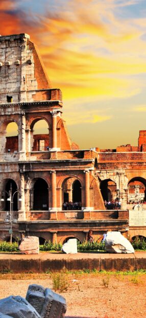 The Rome skyline showcases ancient ruins against a vibrant sunset sky, 2K Mobile Wallpaper