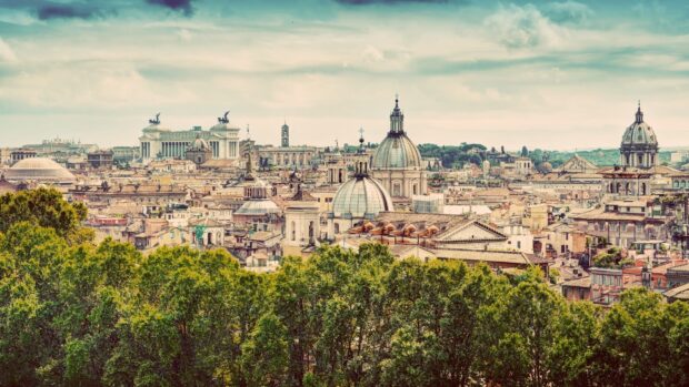 The Rome skyline features historic domes and lush trees under a partly cloudy sky, HD Desktop Wallpaper