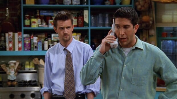 Chandler watching, Ross talks on the phone while Chandler listens closely in the kitchen, HD Desktop Wallpaper