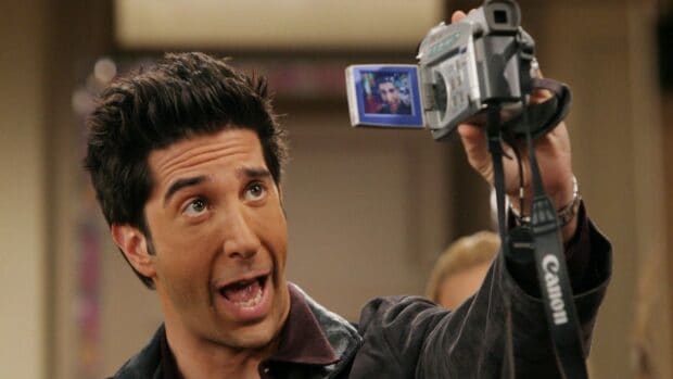 Ross Friends Wallpapers show a man holding a camera capturing his image on the screen, HD Desktop Wallpaper