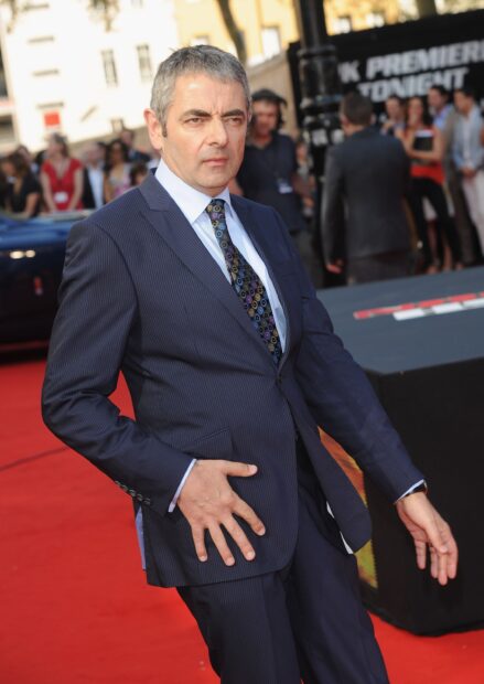Rowan Atkinson wears a navy pinstripe suit with a patterned tie at a public event, 2K Mobile Wallpaper