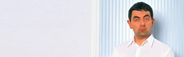 The portrait features Rowan Atkinson wearing a white shirt against a light striped background, 4K Desktop Wallpaper