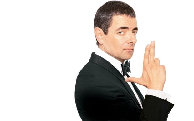 Rowan Atkinson poses with a finger gun gesture wearing a tuxedo, HD Desktop Wallpaper