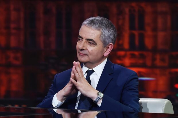 Rowan Atkinson in a suit with hands clasped during an interview, HD Desktop Wallpaper
