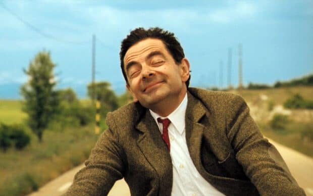 Rowan Atkinson smiles contentedly with eyes closed on a quiet country road, HD Desktop Wallpaper
