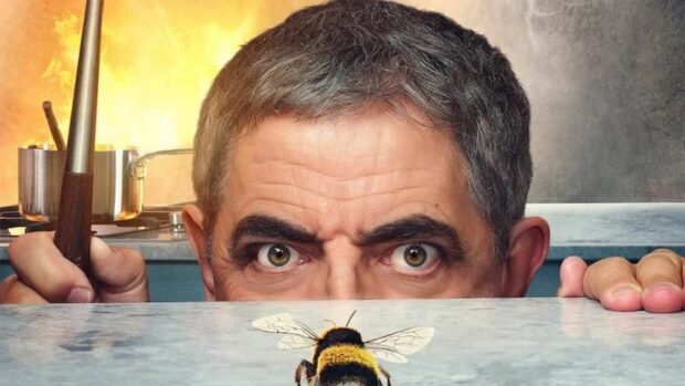 Rowan Atkinson is intensely watching a bee on the surface in a comedic scene, HD Desktop Wallpaper