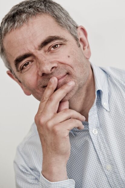 Rowan Atkinson is shown in a close up with a contemplative expression, HD Mobile Wallpaper