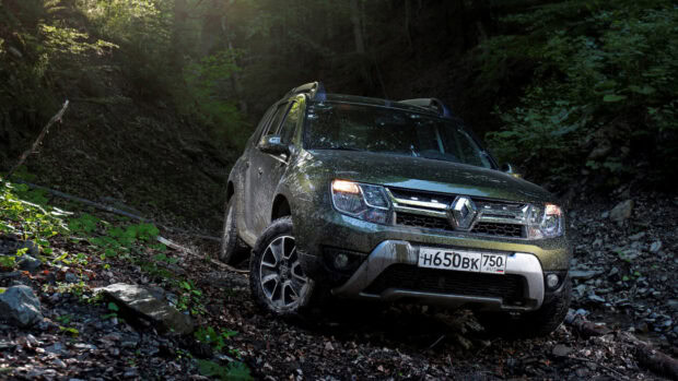 A rugged vehicle is driving off road through a dense forest trail, HD Desktop Wallpaper