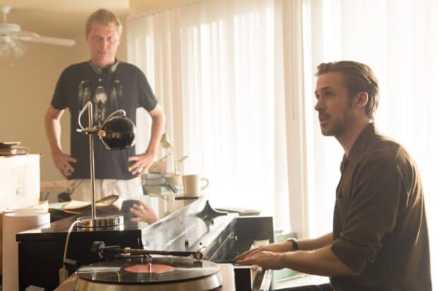 Ryan Gosling is playing piano with a focused expression inside a sunlit room, HD Desktop Wallpaper