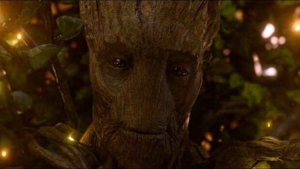 Sad Groot character from Guardians of the Galaxy surrounded by glowing lights in the forest, HD Desktop Wallpaper