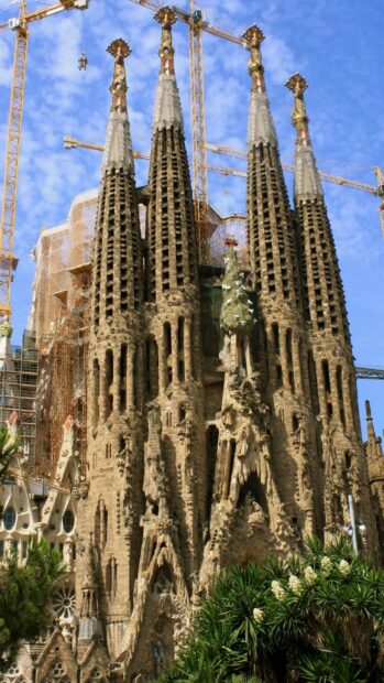 The Sagrada Familia towers rise majestically against a clear blue sky with surrounding cranes, HD Mobile Wallpaper